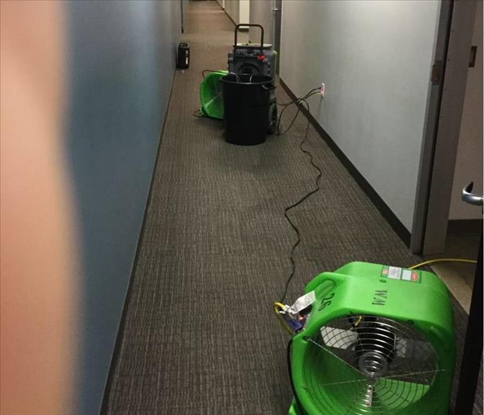 Air Movers drying water damage in commercial building in Irving