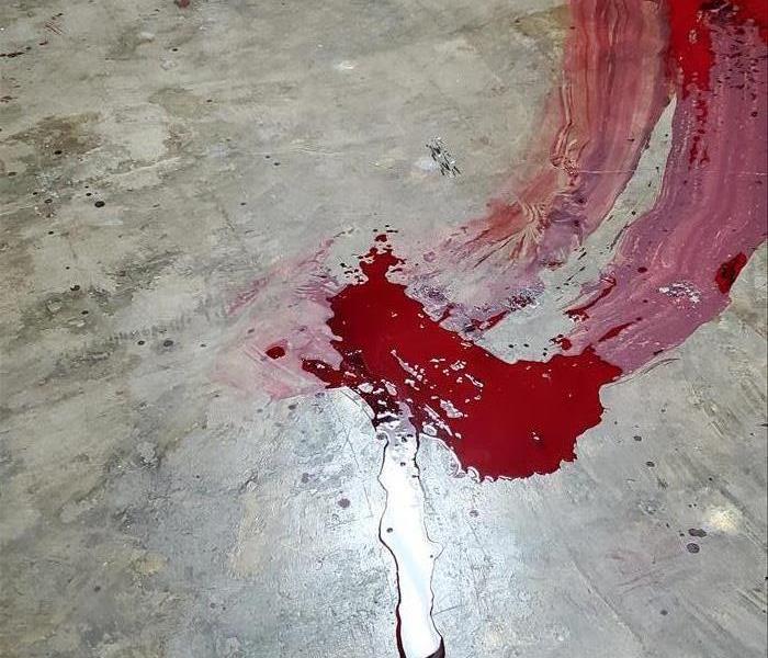 A large swath of blood on a concrete floor